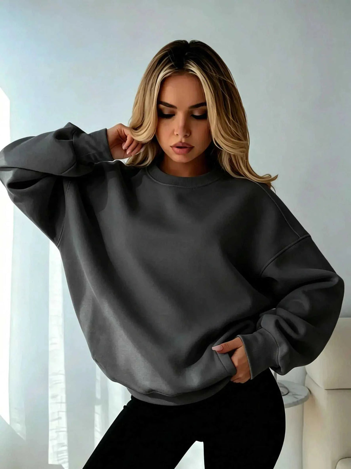 Oversized crewneck sweatshirts for women in charcoal gray fleece, with a plain design, ribbed cuffs, and dropped shoulders.