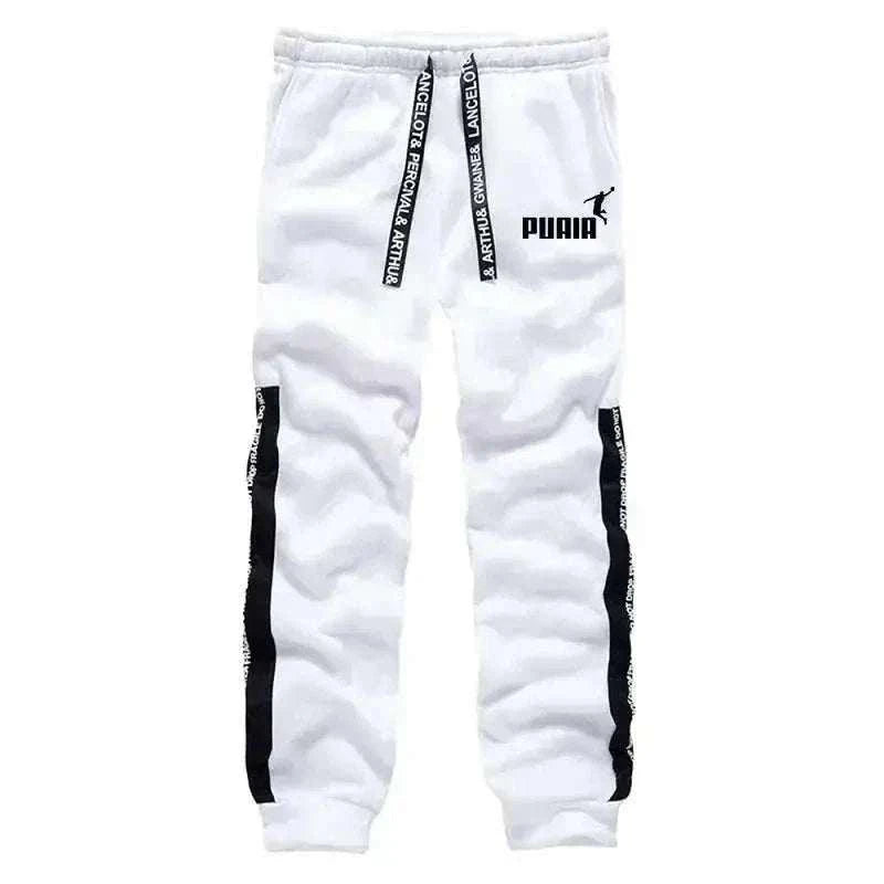 Men's Tracksuit jogger pants in white fabric with black side stripes, drawstring waist, cuffs and Puma logo
